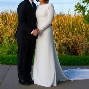 White wedding dress; 5’4” 135 lbs; long sleeve and open back with diamonds hems.